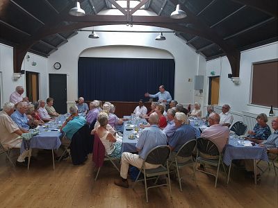 President Neil talks to members, their partners and guests at the meeting.