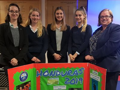 The girls, pictured with their teacher and a n illustrated poster that they had made about their experiences in Honduras.