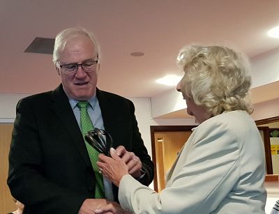 Rtn Lewis Norris receives the “Friendship, strength & energy” award from PP Margaret Griffin at the meeting. 