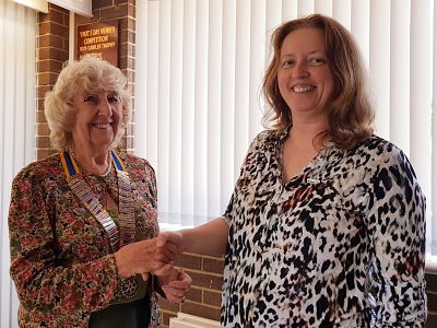 Margaret and Sharon shake hands.