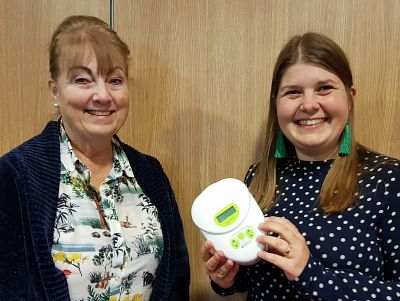 Lyn and Hannah hold a breastpump at our meeting