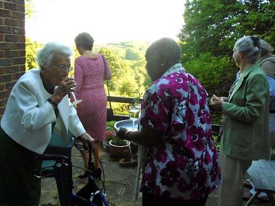 Guests, including Marjorie, enjoy a drink and a lovely view.