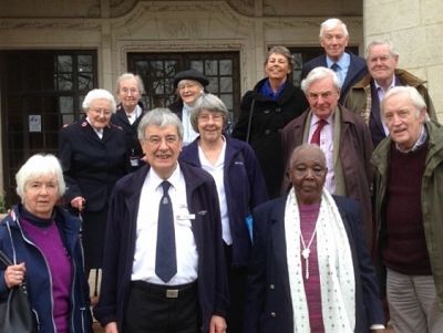 Rotarians, spouses and other visitors outside the college