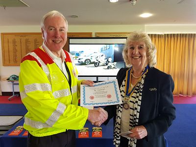 Trevor Sayer from SERV Kent hands a certificate of thanks to President Margaret Griffin