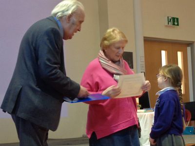 Picture: Rtns Alan and Mary give out an Award to a youngster from St John C of E School. 