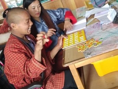 Special needs teacher Tshering Dolkar assists a student at the school. 