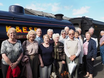 Club members pose for a photo beside one of Kent & East Sussex Railway