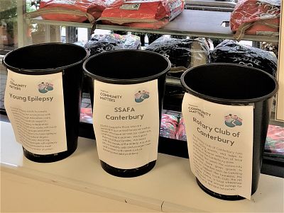 Our Community Matters bucket at Waitrose, Canterbury, alongside buckets from two other worthy causes.