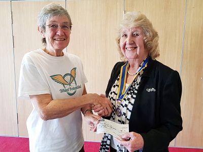 Beatrice Shire, one of the Directors of Wheel Potential, receives our cheque from President Margaret Griffin.